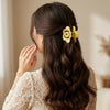 Close-up of the Hollow Rose Matte Hair Claws showing rose motif
