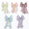 Close-up of the Powder Tulip Dangling Bow Clips showing tulip motif