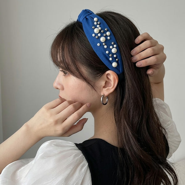 Close-up of the Pearl Studded Knotted Headband showing stud setting