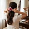 Pink Plumeria Flower Hair Clip hair claw clip worn on model – styled for women